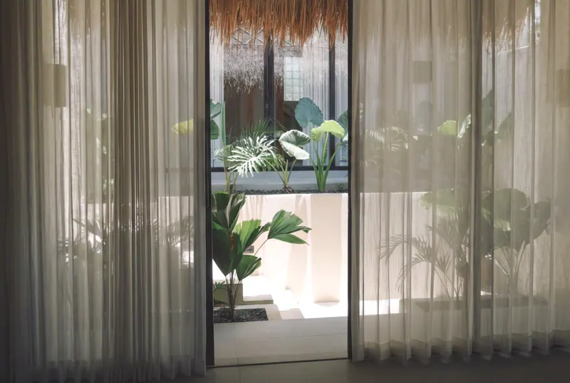 Linen curtains opening to the bathroom garden