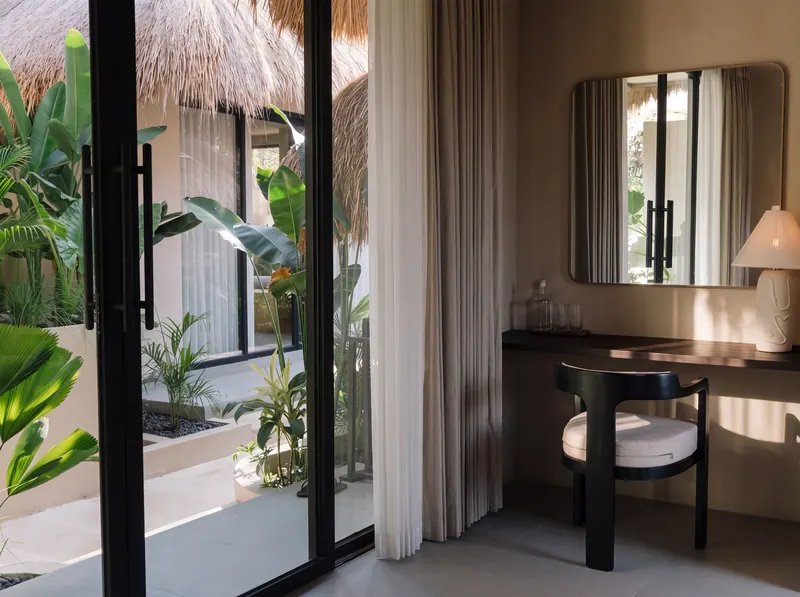 Desk and mirror by sliding glass doors that open to the garden
