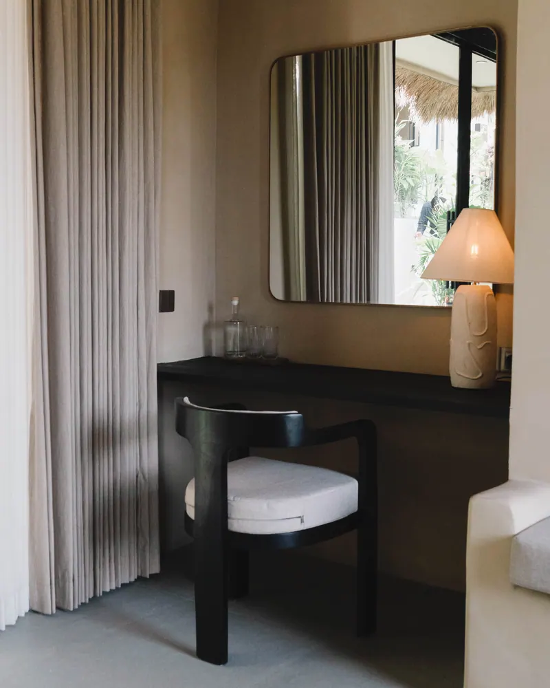 Dressing table with a mirror, lamp and dark chair